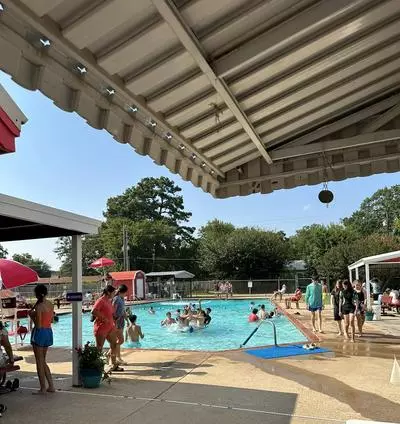 Boys and girls swim in a pool.